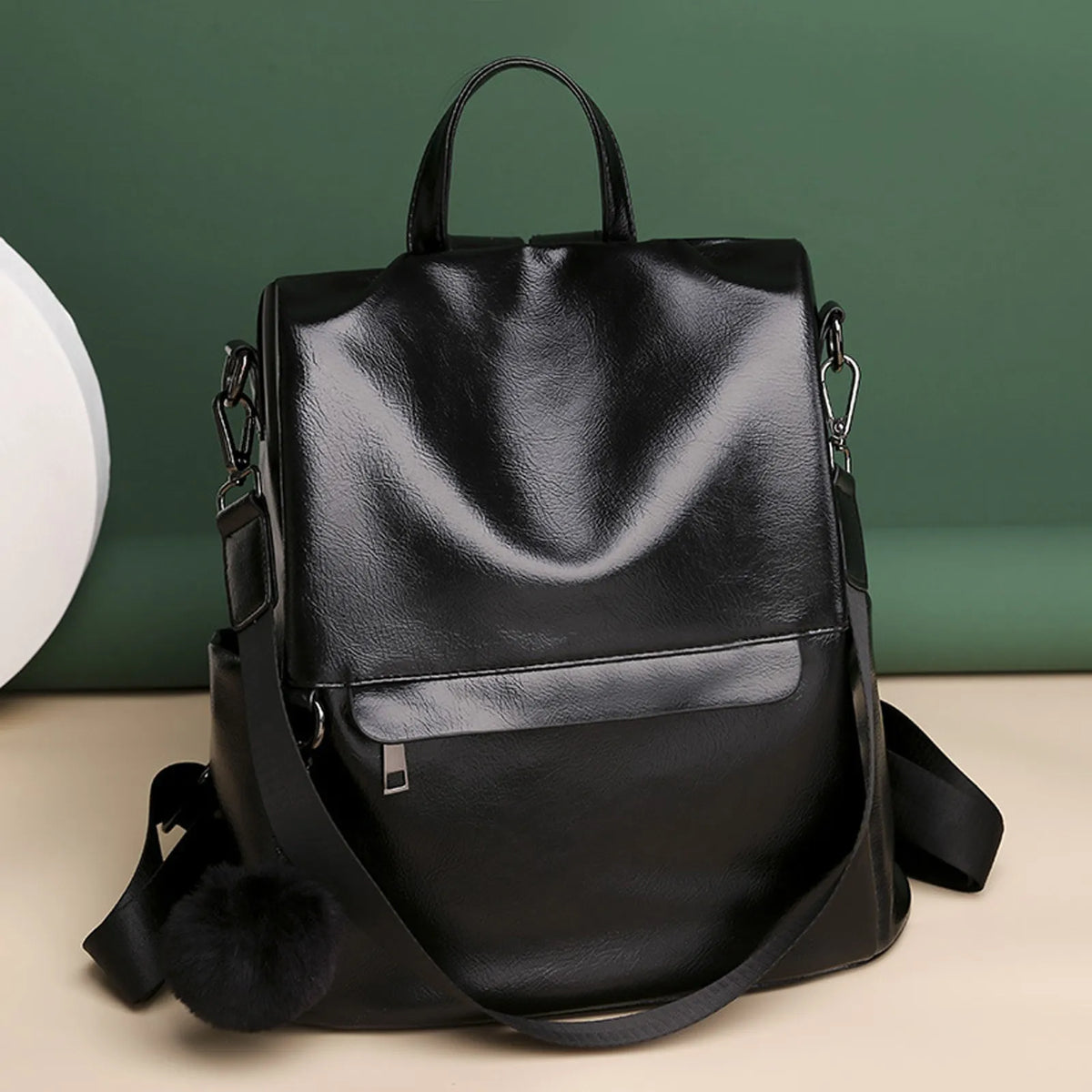 Image of black minimalist korean backpack against green textured background