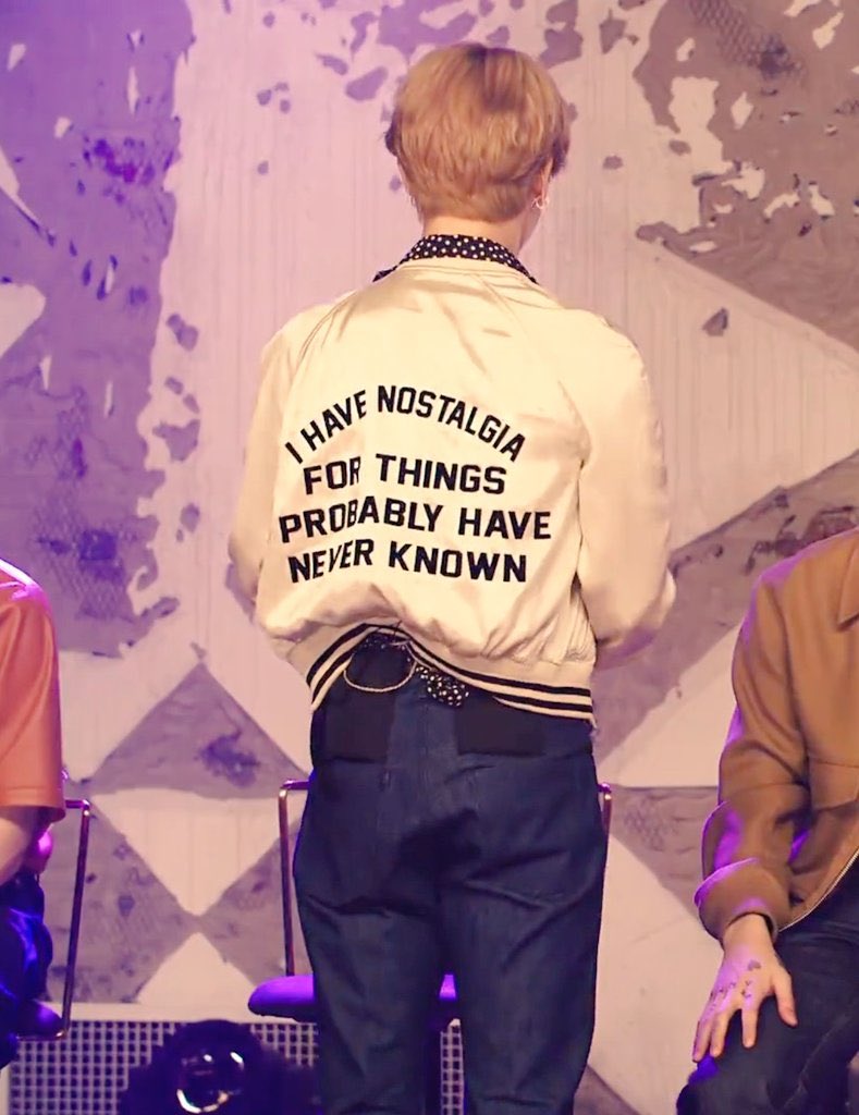 Photo of Jimin backing the crowd in his Nostalgia Bomber Jacket